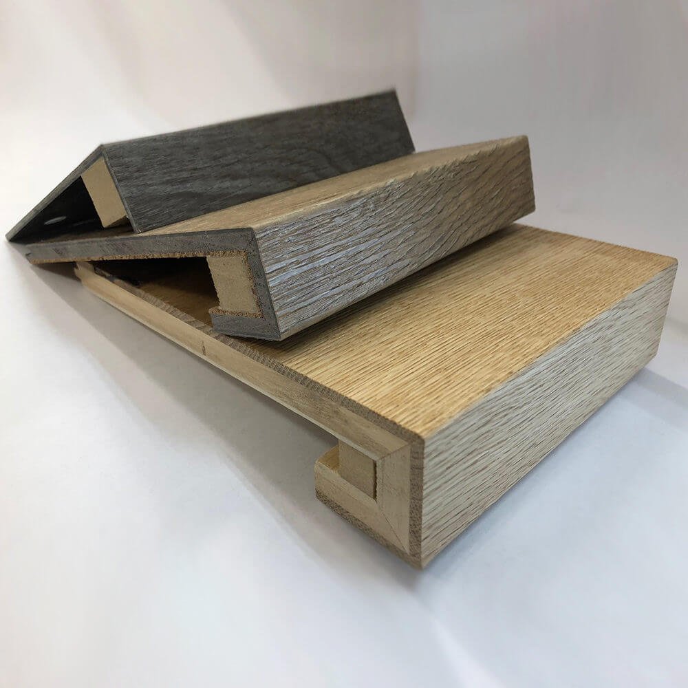 Three different colour custom made wooden stair nosing samples with a white background